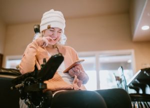Wheelchair girl phone at home